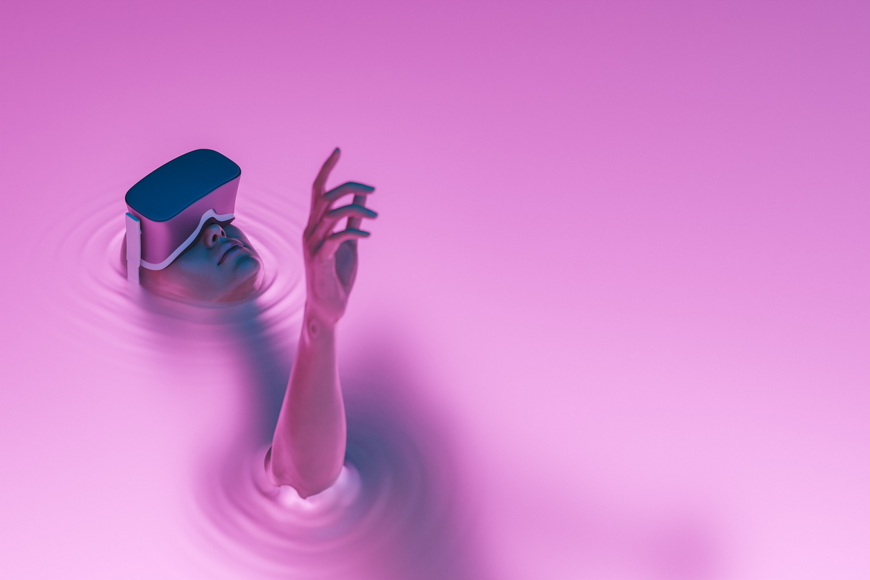 Woman wearing VR headgear in a pool of pink water