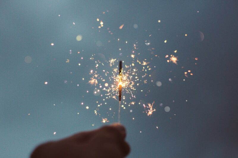 person holding lighted sparklers representing innovation from intrapreneurs and intrapraneurship