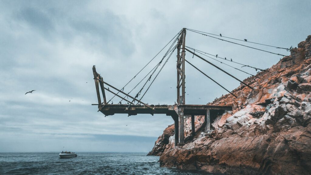 metal bridge near boat during daytime. Leadership development is broken.