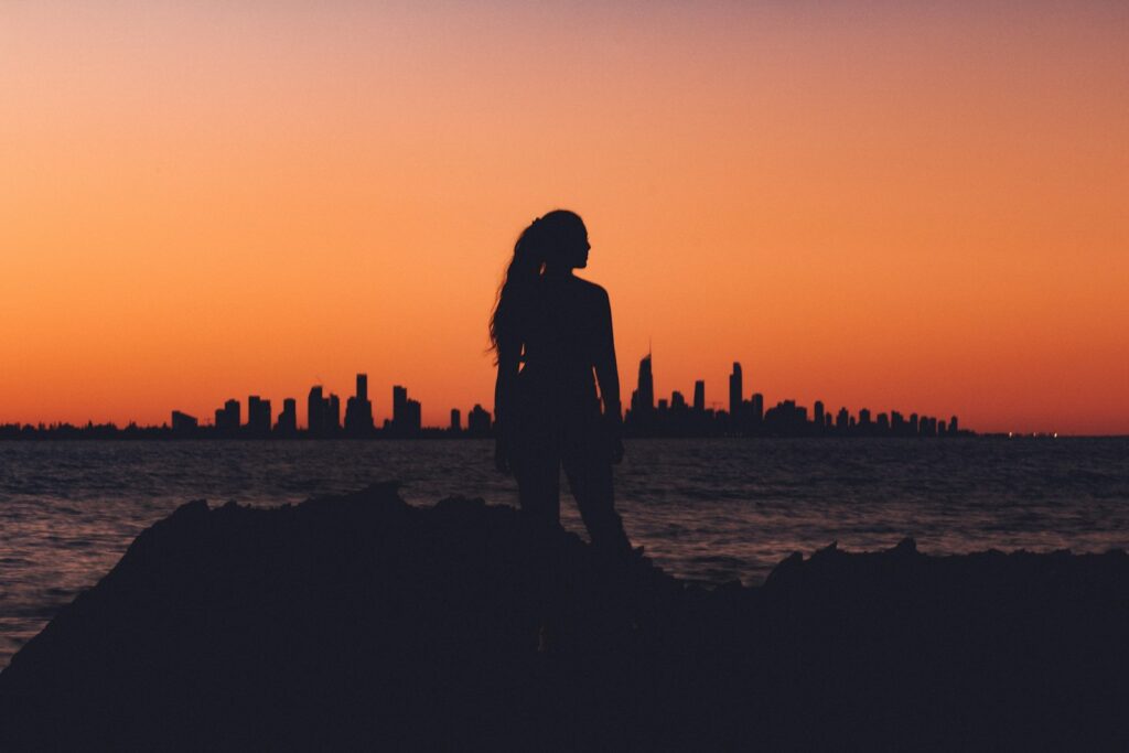 silhouette of woman near shoreline. The future-focused CLO: Anticipating and building capabilities for tomorrow