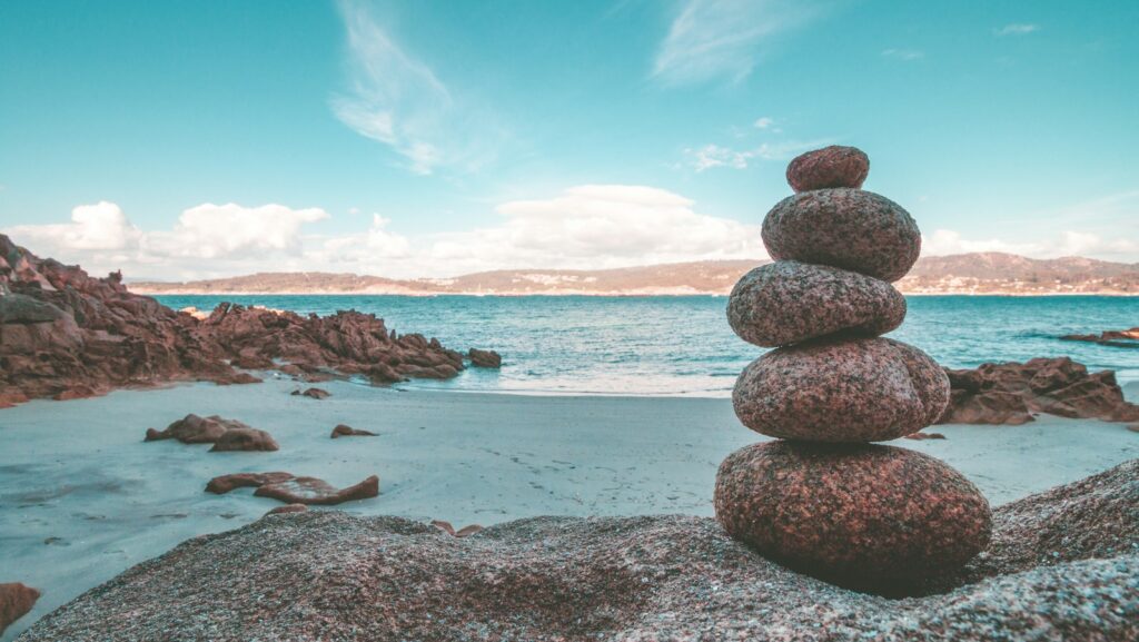 gray rocks on seashore during daytime.