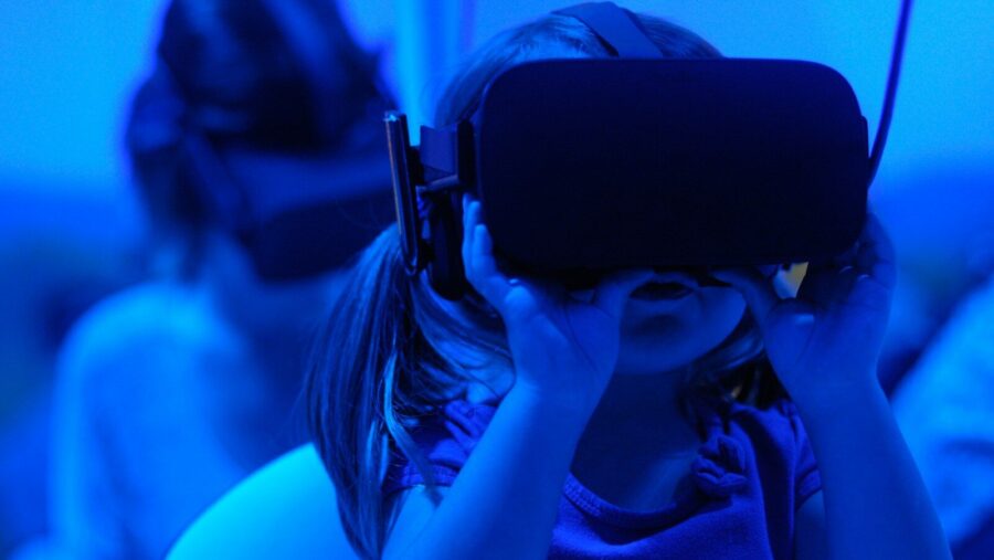 girl using VR goggles, young people