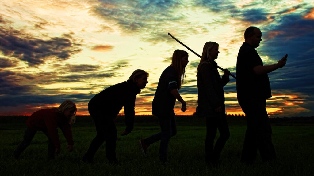 silhouette photo of group people standing on grass: future evolution