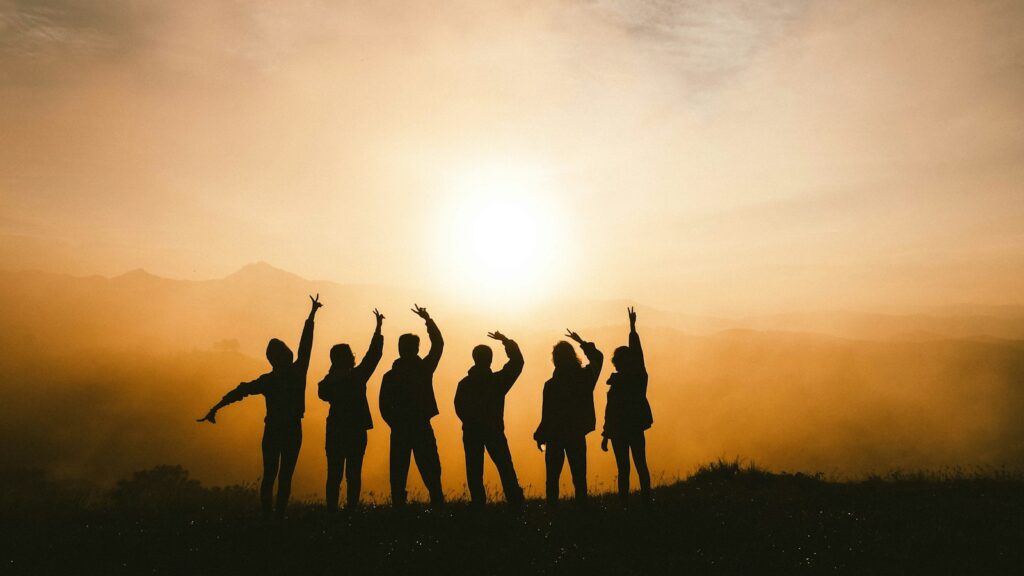 Tuckman’s team development model, silhouette photo of six persons on top of mountain