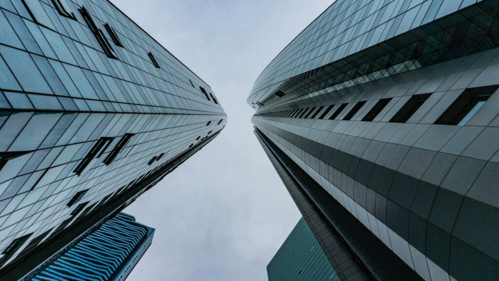 worm's-eye view photography of buildings under cloudy sky