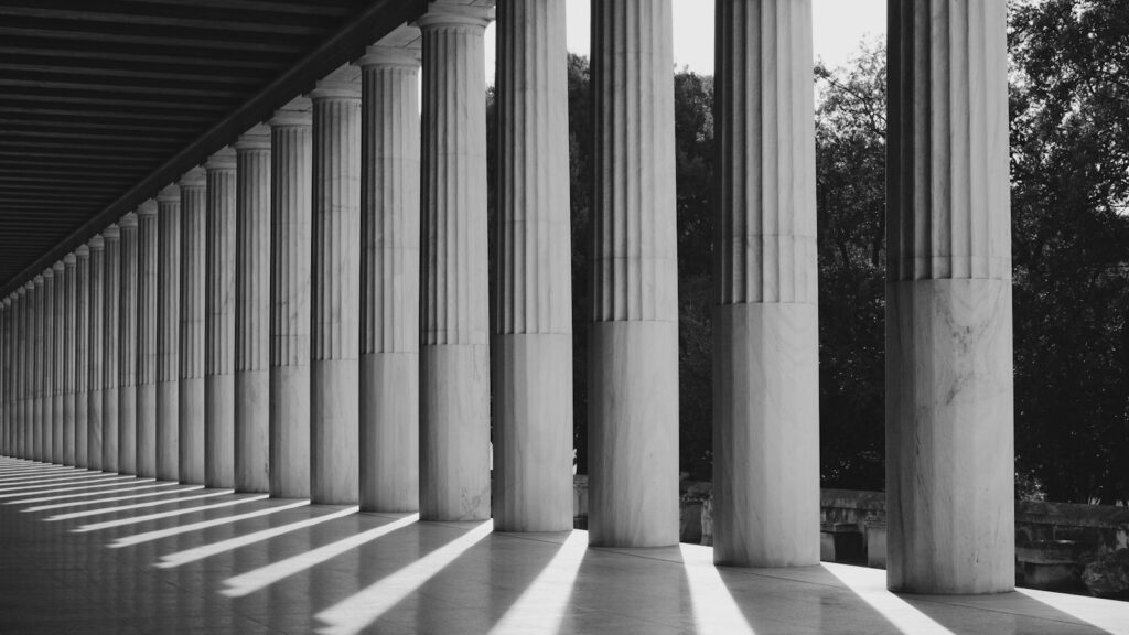 grayscale photo of a building's pillars, depicting foundations in learning objectives and outcomes
