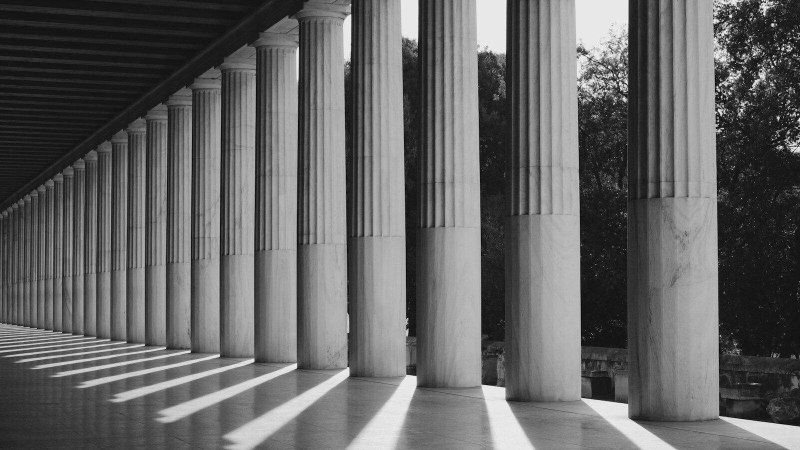 grayscale photo of a building's pillars, depicting foundations in learning objectives and outcomes