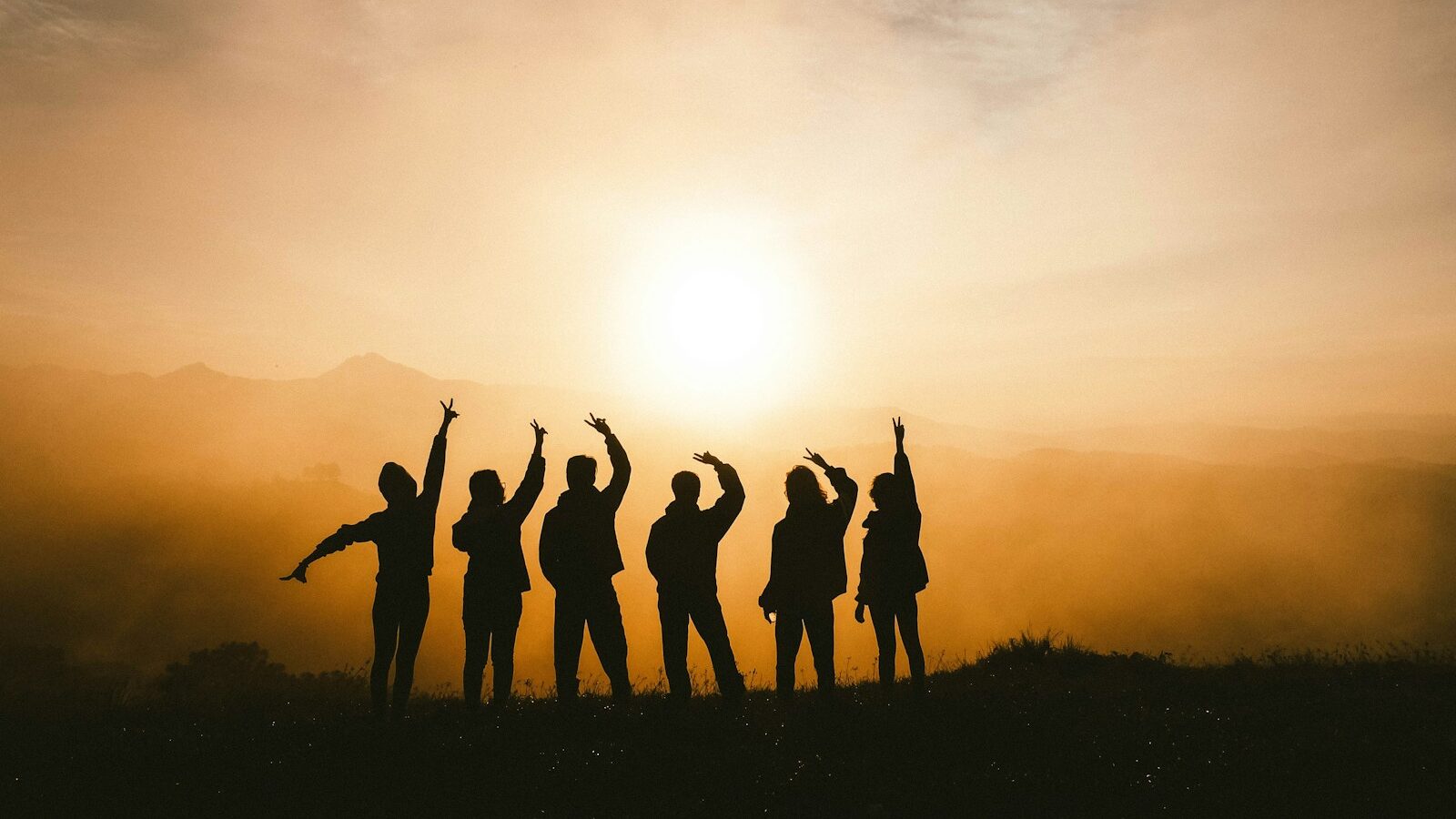 silhouette photo of six persons on top of mountain