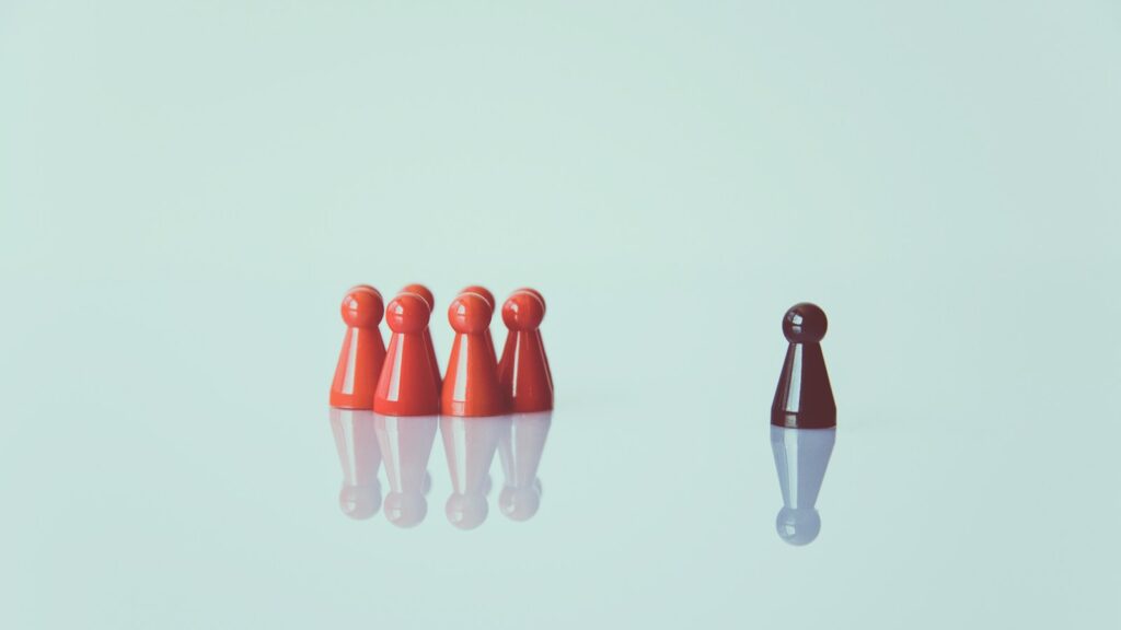 brown game pieces on white surface, depicting generational stereotyping